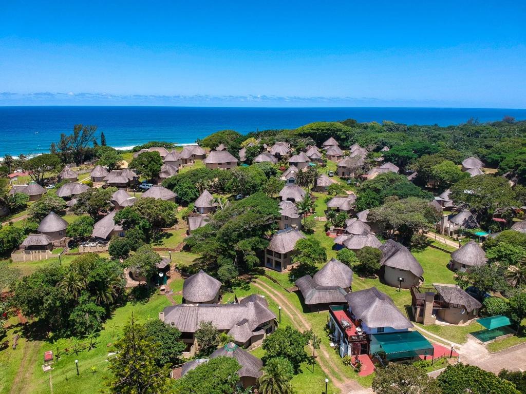 an aerial view of a village with thatched roofs at Anchors Aweigh in Hibberdene