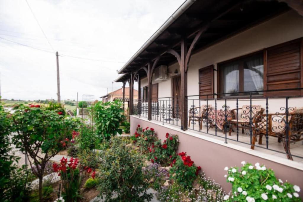 a balcony with benches and flowers on a building at Red Roses-Traditional House in Katerini