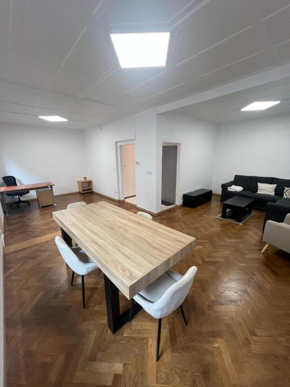 a large room with a wooden table and chairs at Maison 3 chambres in Strasbourg