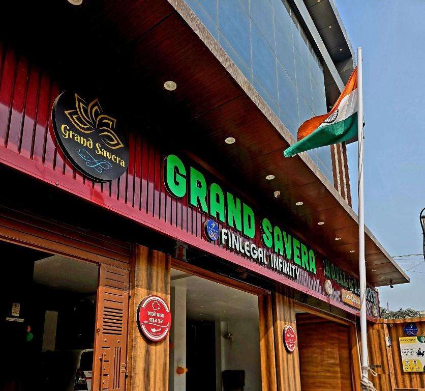 a building with a flag on the side of it at Grand Savera in Saharsa