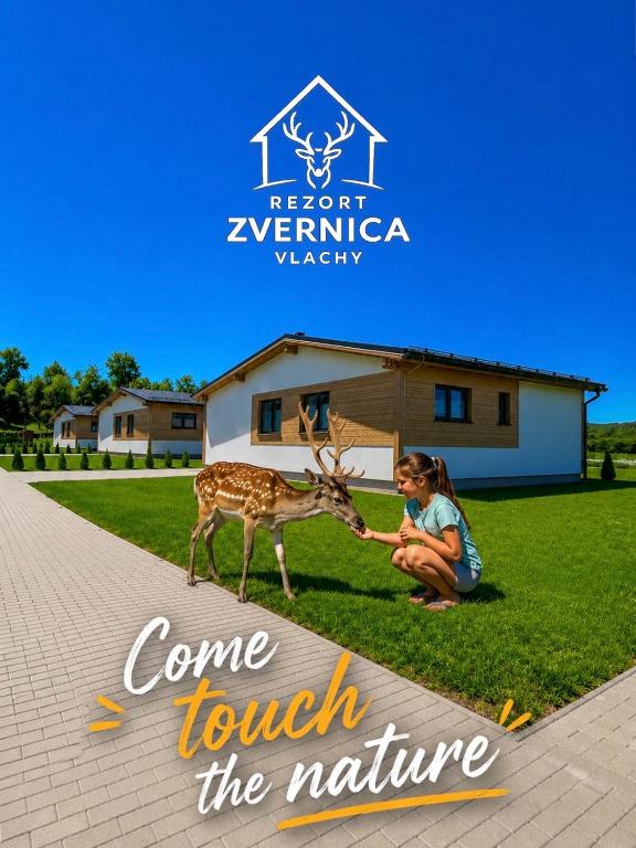 a young girl petting a deer at a zoo at Rezort Zvernica Vlachy - Family & Fun in Vlachy