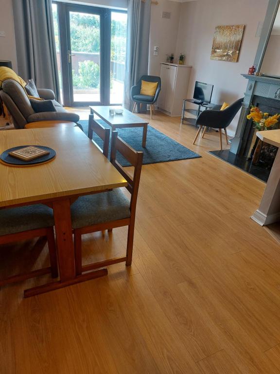 a living room with a couch and a table at Coastal Apartment in Malahide