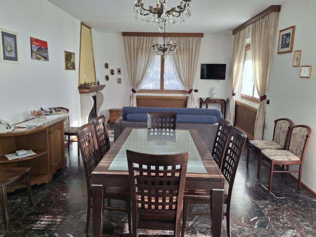 a living room with a couch and a table and chairs at Retica Tirano garage EV Station & Biliards BBQ e private Parking in Tirano
