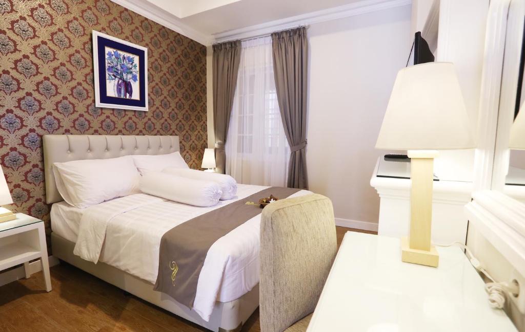 Voodi või voodid majutusasutuse F Hotel Jakarta toas