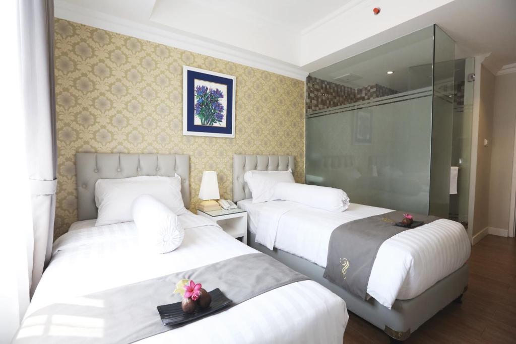 Voodi või voodid majutusasutuse F Hotel Jakarta toas