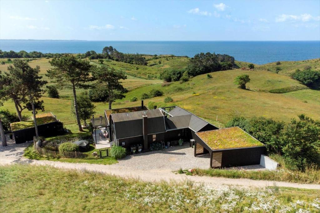 a house on a hill with the ocean in the background at 20165-Samso-Marup-Bakkevej-14 in Mårup