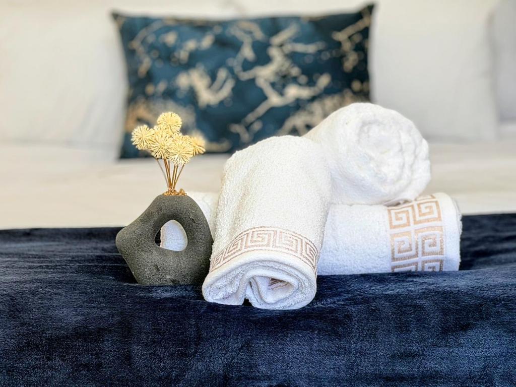 a towel on a bed next to a towel at Signature Suite in Kempton Park