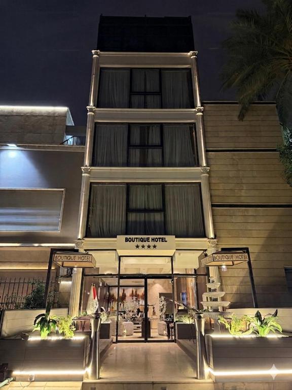 a building with a store front at night at Boutique Hotel in Baghdād
