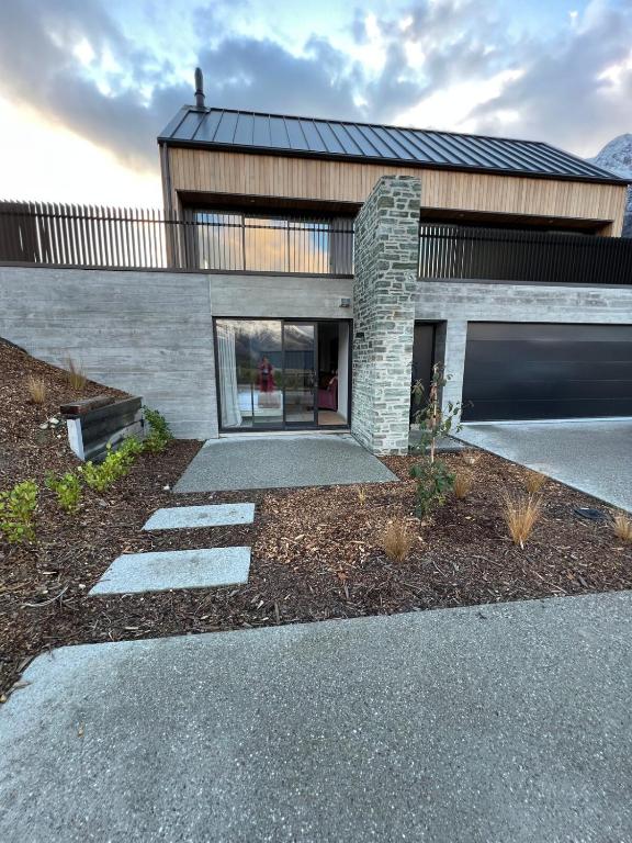 a house with a walkway in front of it at Jacks Point Getaway in Queenstown Airport
