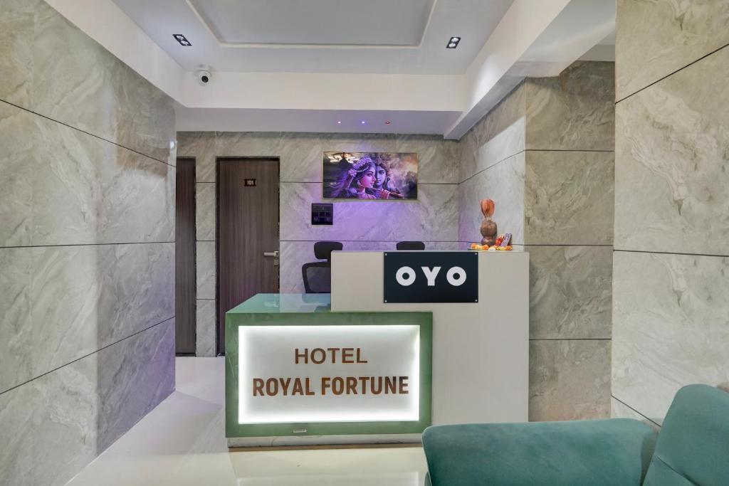 a hotel lobby with a hotel royal furniture sign at Hotel O Royal Fourtune in Surat