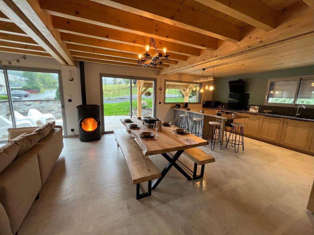 a large living room with a table and a stove at Le chalet de Catarrabes in Cauterets