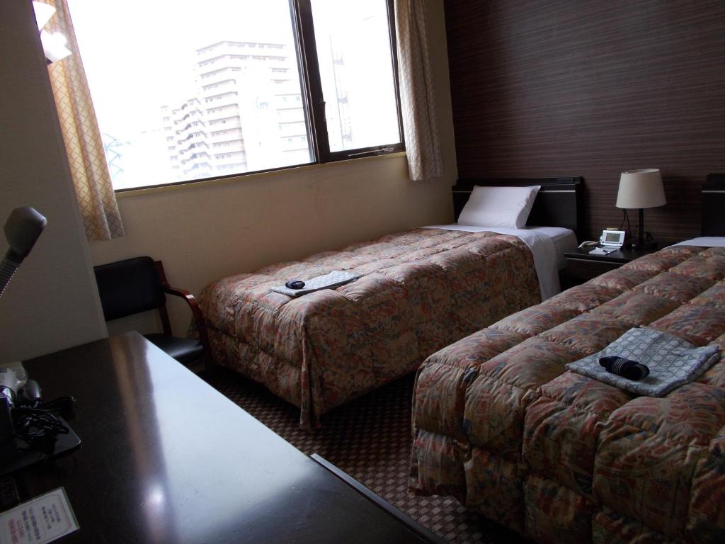 Postel nebo postele na pokoji v ubytování Hotel Matsuyama Hills