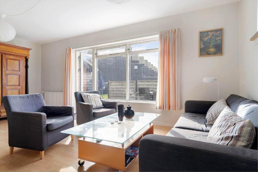 a living room with a couch and chairs and a table at 20432-Samso-Klintevej-6 in Ballen
