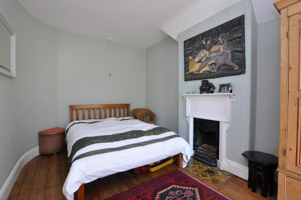 a bedroom with a bed and a fireplace at Hollins Lodge in Grosmont
