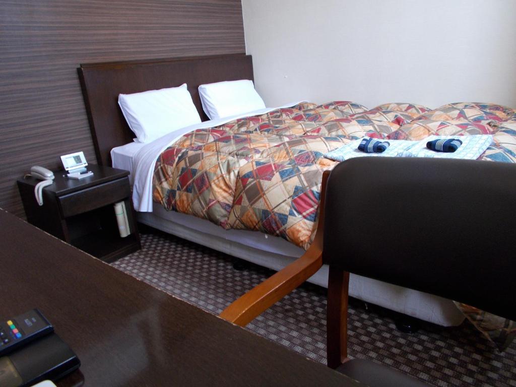 Postel nebo postele na pokoji v ubytování Hotel Matsuyama Hills