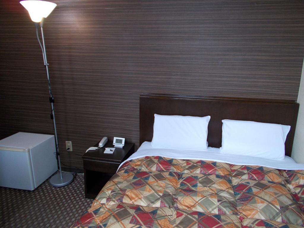 Postel nebo postele na pokoji v ubytování Hotel Matsuyama Hills