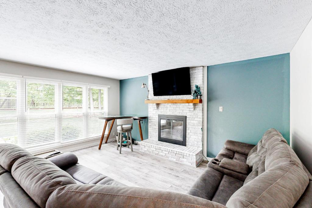 a living room with a couch and a fireplace at 'Heart Pond Resort' Home in Carmel-Westfield Area in Carmel