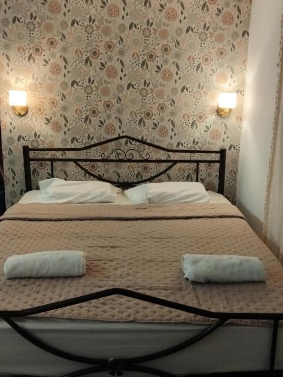 a bedroom with a bed with two pillows on it at Efterpi seaside house in Chrysi Ammoudia