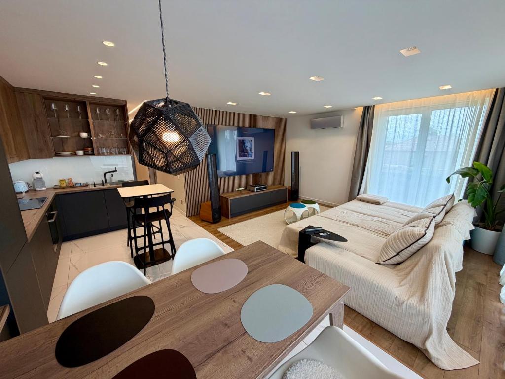 a kitchen and a living room with a bed and a table at Rupphill Apartment in Budapest