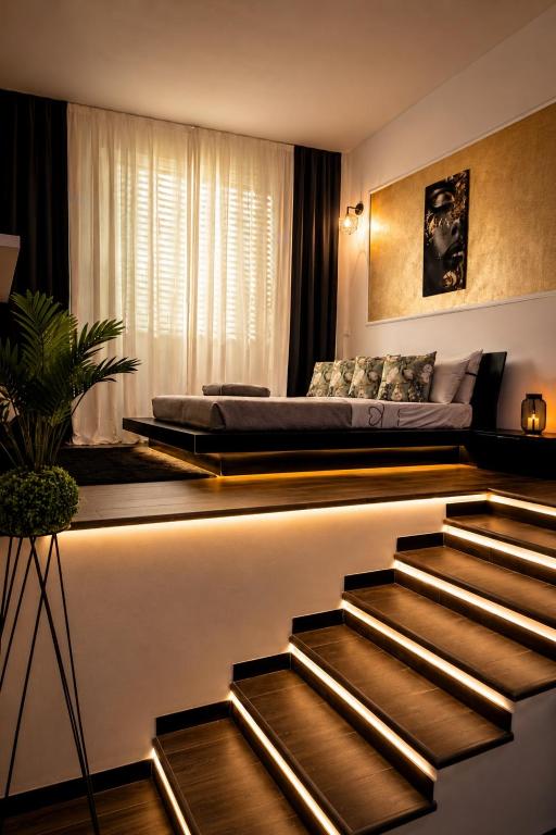 a bedroom with a bed and stairs in a room at Rebecca's Noir Suite in Reggio Emilia