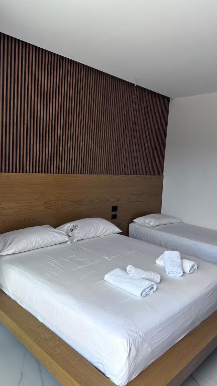 a bedroom with two beds with white towels on them at Vila Klea in Ksamil