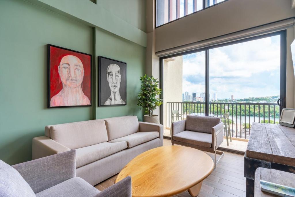 a living room with a couch and a table at Stylish Duplex Loft - Panoramic Rooftop Pool in Cartagena de Indias