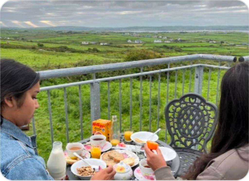 two women sitting at a table eating food at Moher Heights in Liscannor