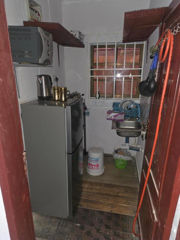 a small kitchen with a refrigerator and a window at J&J Guest Apartment in Eggan