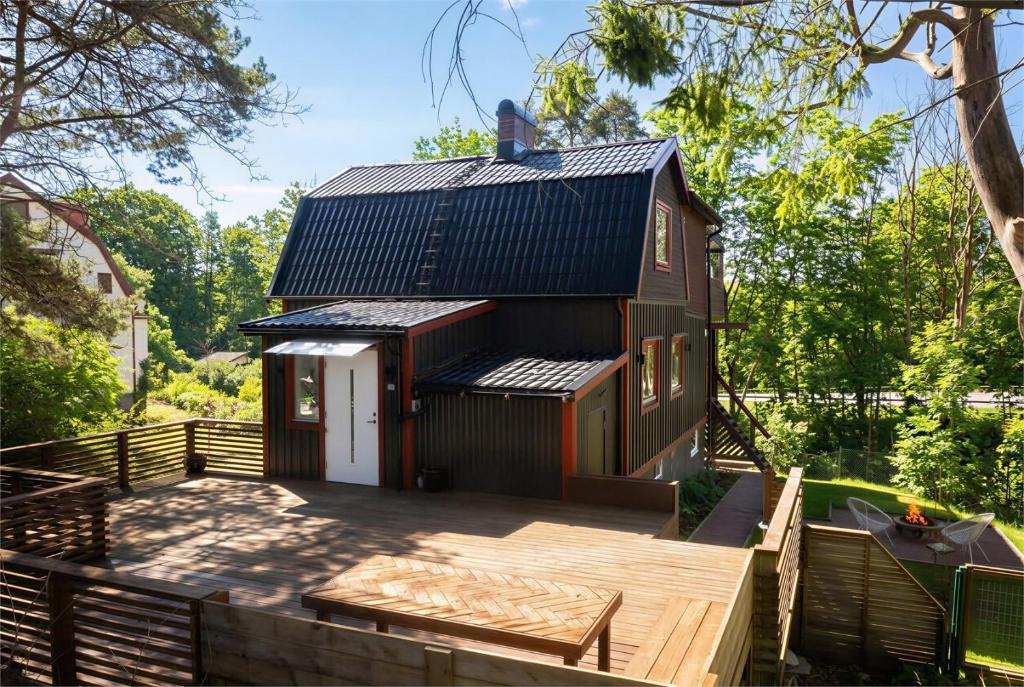 a home with a deck and a house at the Little Oasis In Gothenburg in Gothenburg