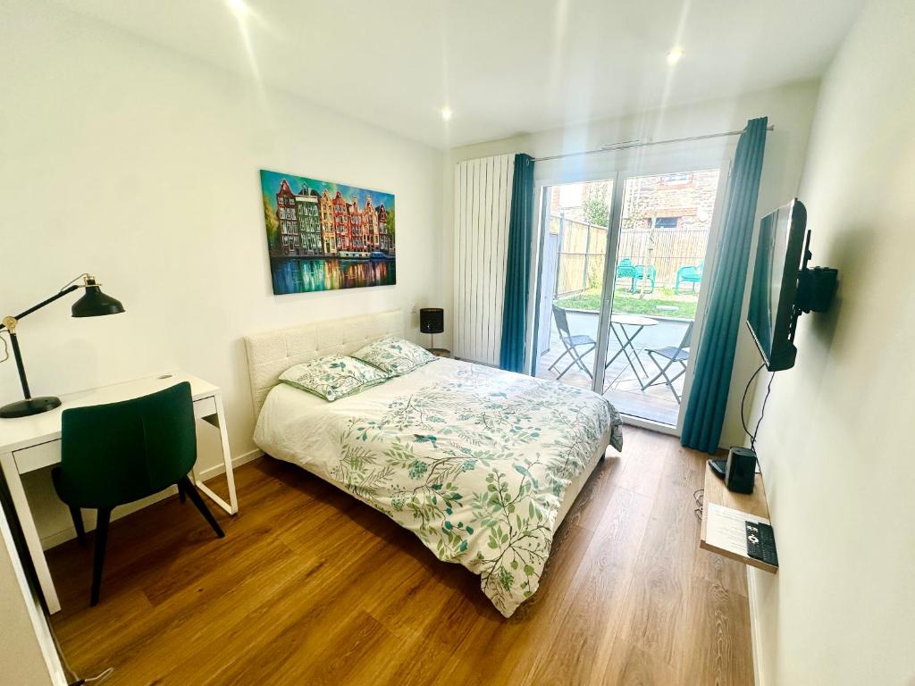 a bedroom with a bed and a desk and a window at Gare sud in Rennes