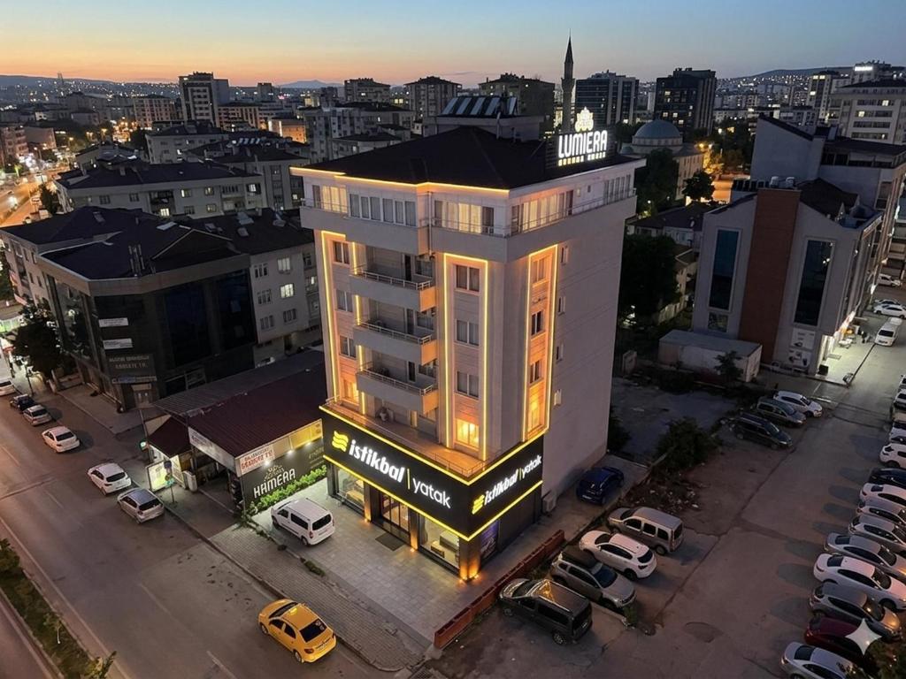 an overhead view of a building with cars parked in a parking lot at Lumiera Suites Hotel in Nilüfer