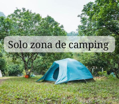 a blue tent under a sign that reads solo zona de camping at Ecocamping oasis in San Francisco