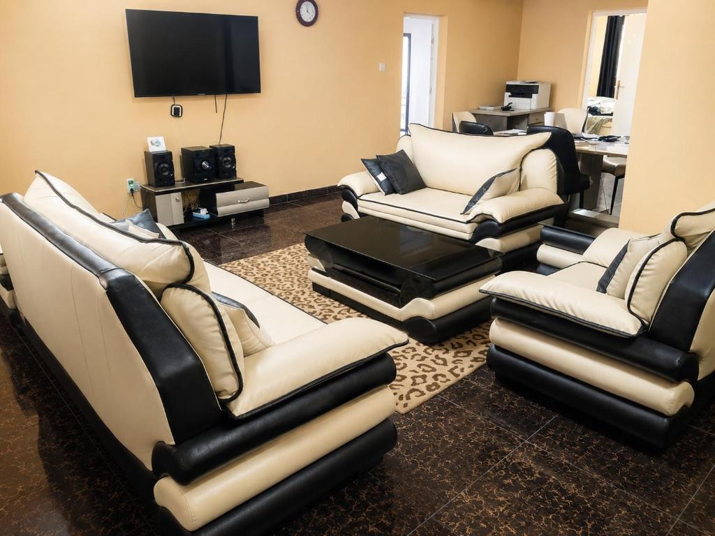 a living room with couches and a flat screen tv at Tee's Place in Coker