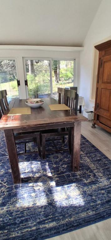a wooden dining room table with chairs on a rug at Walnuts in Owings Mills