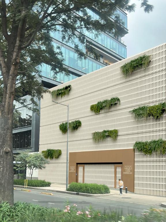a building with plants on the side of it at Casa Américas in Mexico City