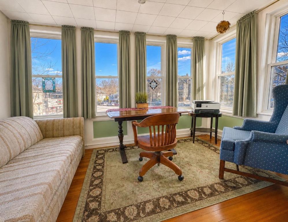a living room with a table and a couch at Victorian Condo in Boston