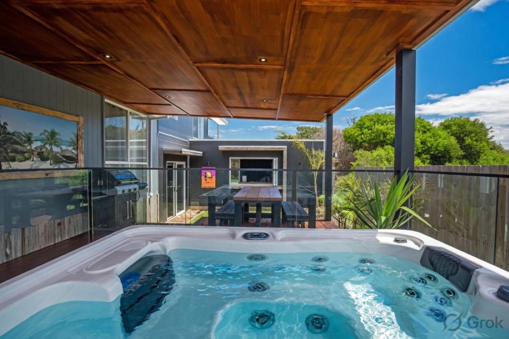 a hot tub on the deck of a house at Island Getaway Cape Woolamai in Cape Woolamai