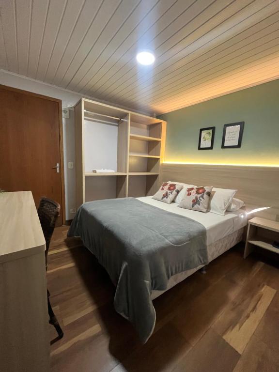 a bedroom with a large bed in a room at Queiroz Palace Hotel in Siqueira Campos