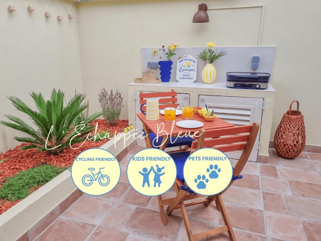 a patio with a table and chairs with signs on them at L'Échappée Bleue, maison à 200m de la mer pour vacances et travail in Saint-Brevin-les-Pins