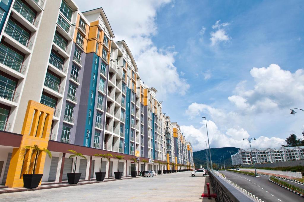 a row of tall buildings on a city street at DreamScape Apartment @ Golden Hill in Cameron Highlands