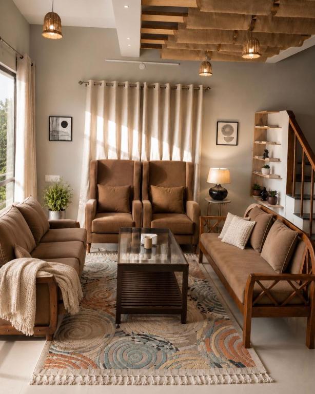a living room with two couches and a coffee table at Chetan's Villa in Bhīm Tāl