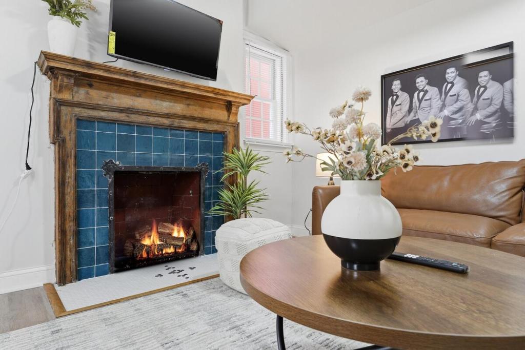 a living room with a fireplace and a couch at Keifer Suite in Detroit