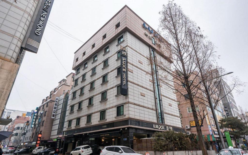 a building on a city street with cars parked at Nowon Luxe in Seoul