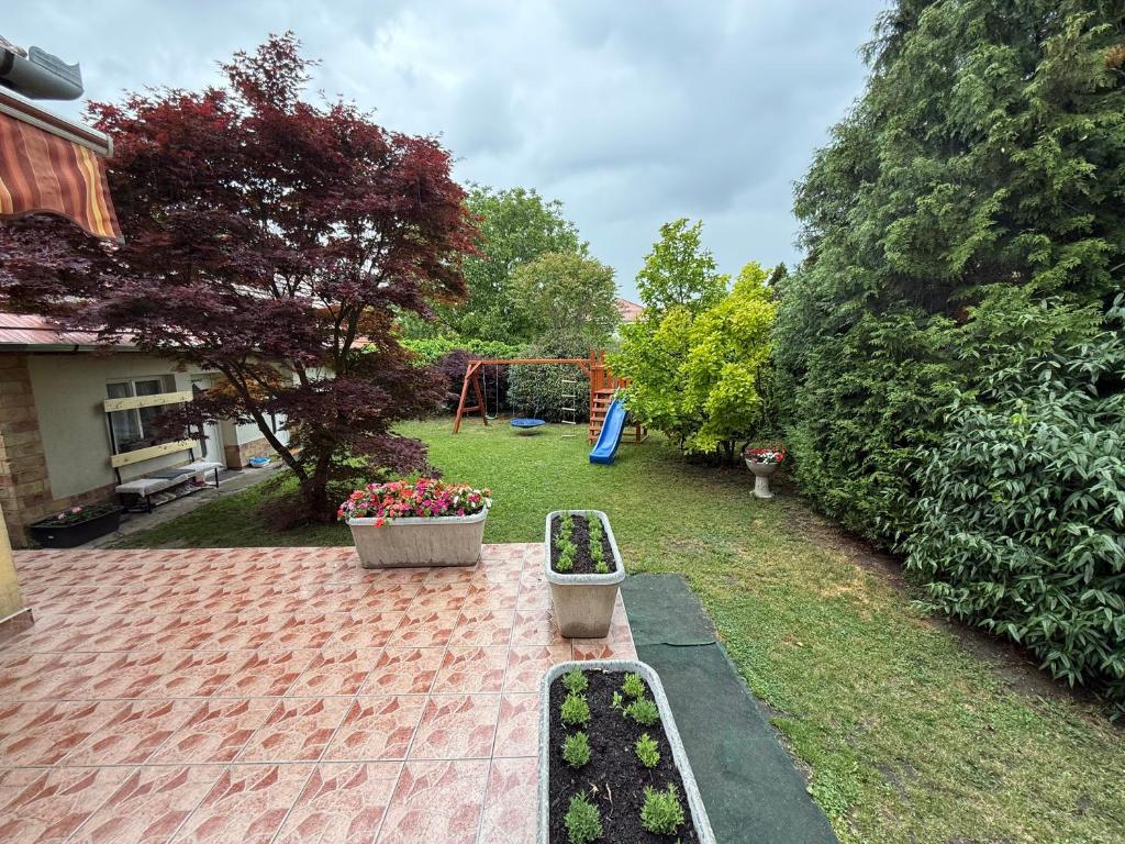 a garden with a bench and a playground at 7Csakra Vendeghaz in Szentendre