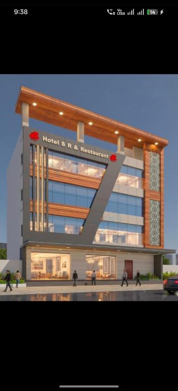 a large building with people walking in front of it at Hotel SR & restaurant in Bhauvāpār