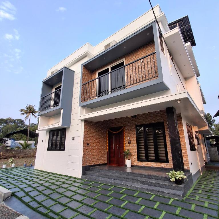 a house with a walkway in front of it at Nana's Residency, Cochin in Alwaye