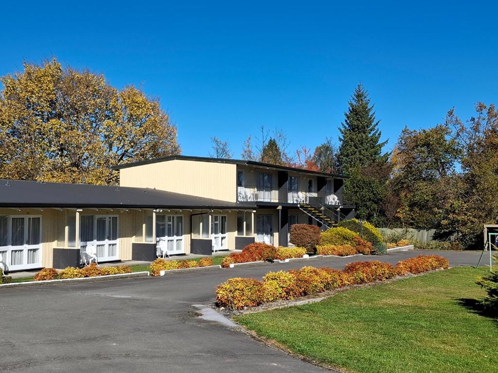 a building with a parking lot in front of it at Spa Lodge Motel in Hanmer Springs