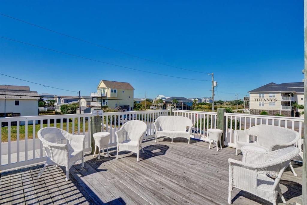 a group of chairs sitting on a deck at Surf City Stay - Motel Unit - Walk to Beach in Surf City