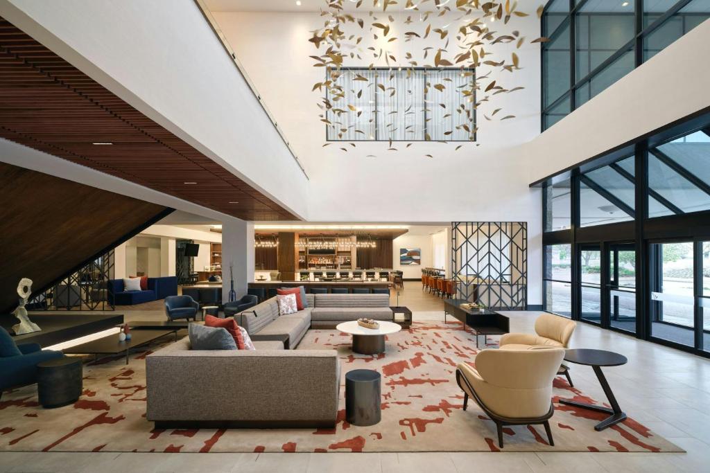 a lobby with couches and chairs and a chandelier at Sheraton Denver West Hotel in Lakewood
