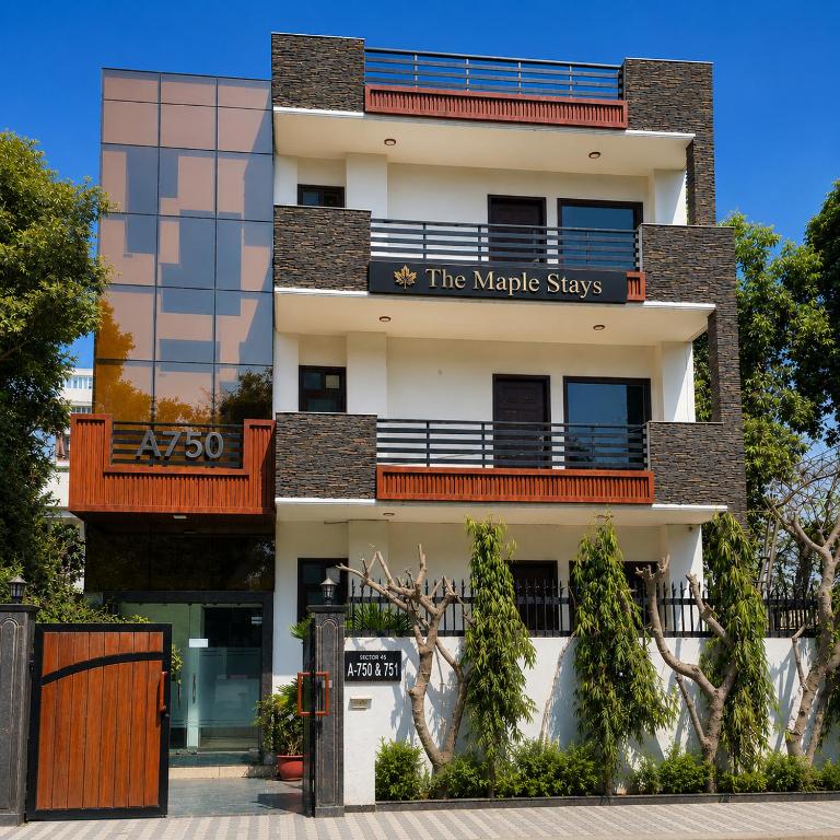 a large white building with a sign on it at The Maple Stays in Gurgaon